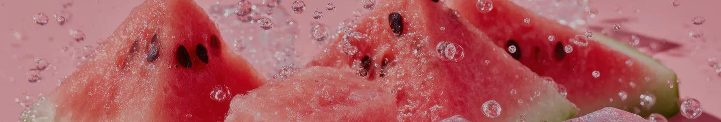 Slices of watermelon with seeds on a pink background